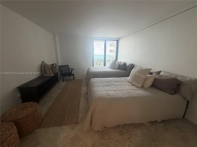 a bedroom with a bed and a view of bathroom