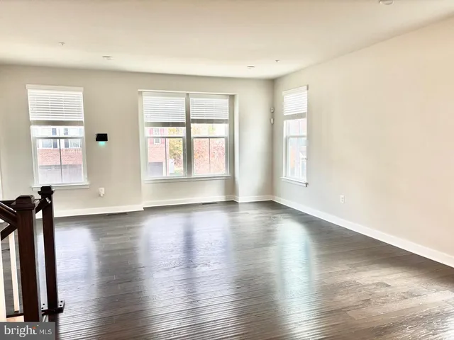 a large bed sitting in a kitchen next to a window