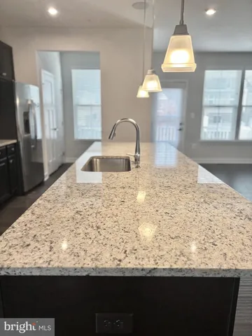 a large kitchen with kitchen island a sink counter space and a large window