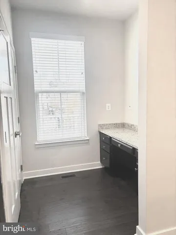 a kitchen with granite countertop stainless steel appliances and wooden cabinets