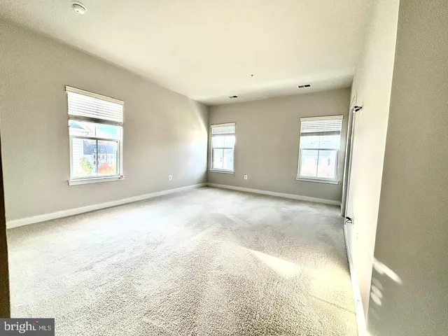 a bathroom with a granite countertop double vanity sink and mirror