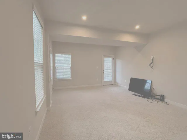 a bathroom with a granite countertop toilet sink and mirror