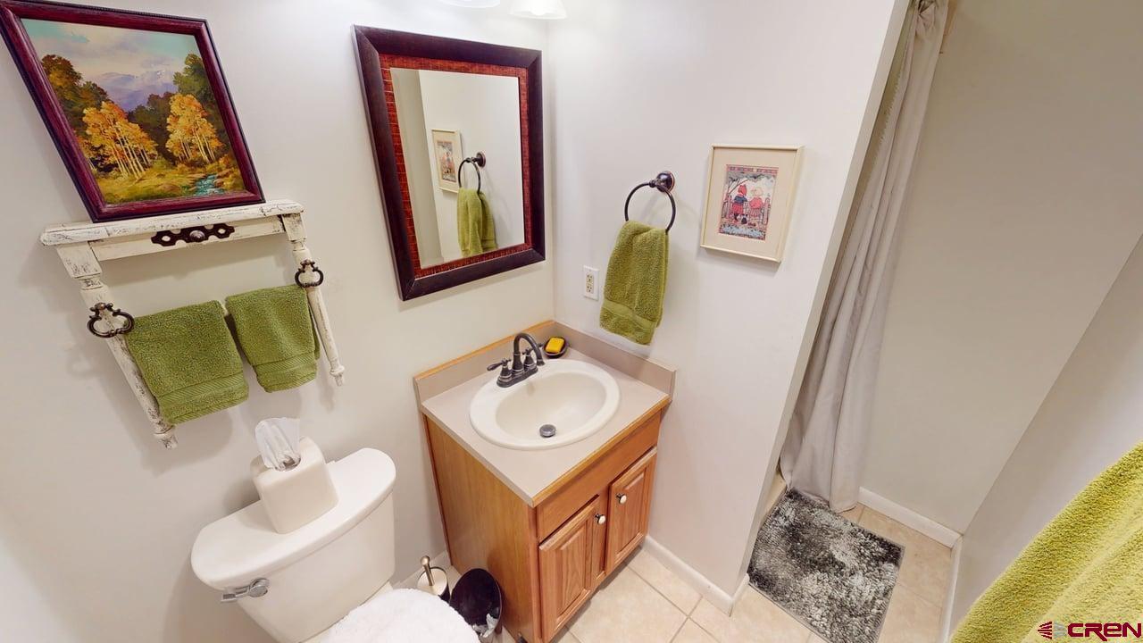 96 El Rio Drive Alamosa, CO 81101 - Photo 12 of 18 a bathroom with a toilet sink and mirror