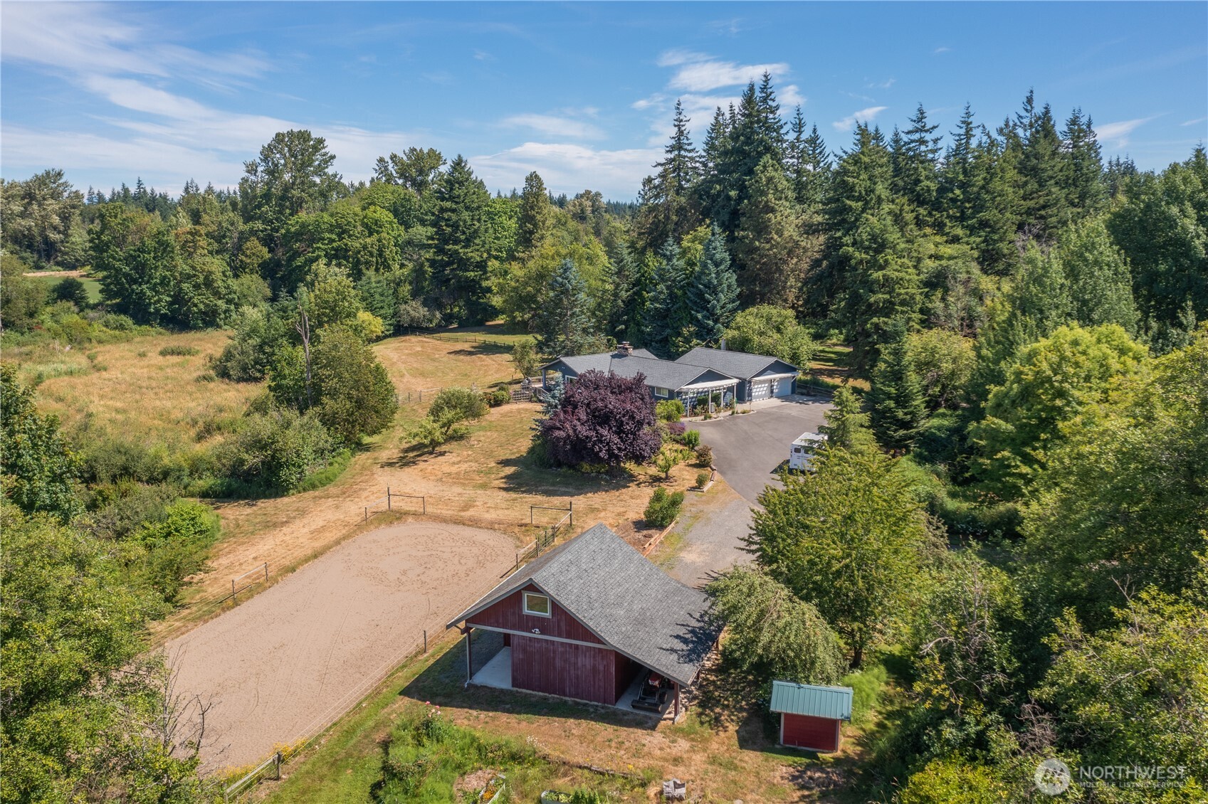 an aerial view of a house with yard swimming pool and lake view