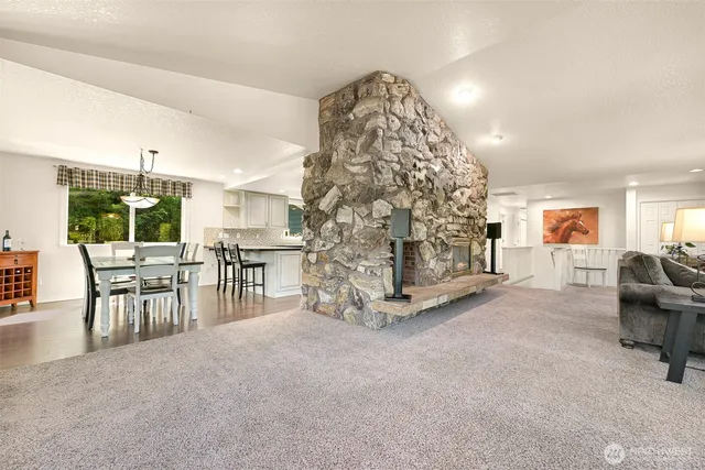 a kitchen with granite countertop white cabinets and white stainless steel appliances