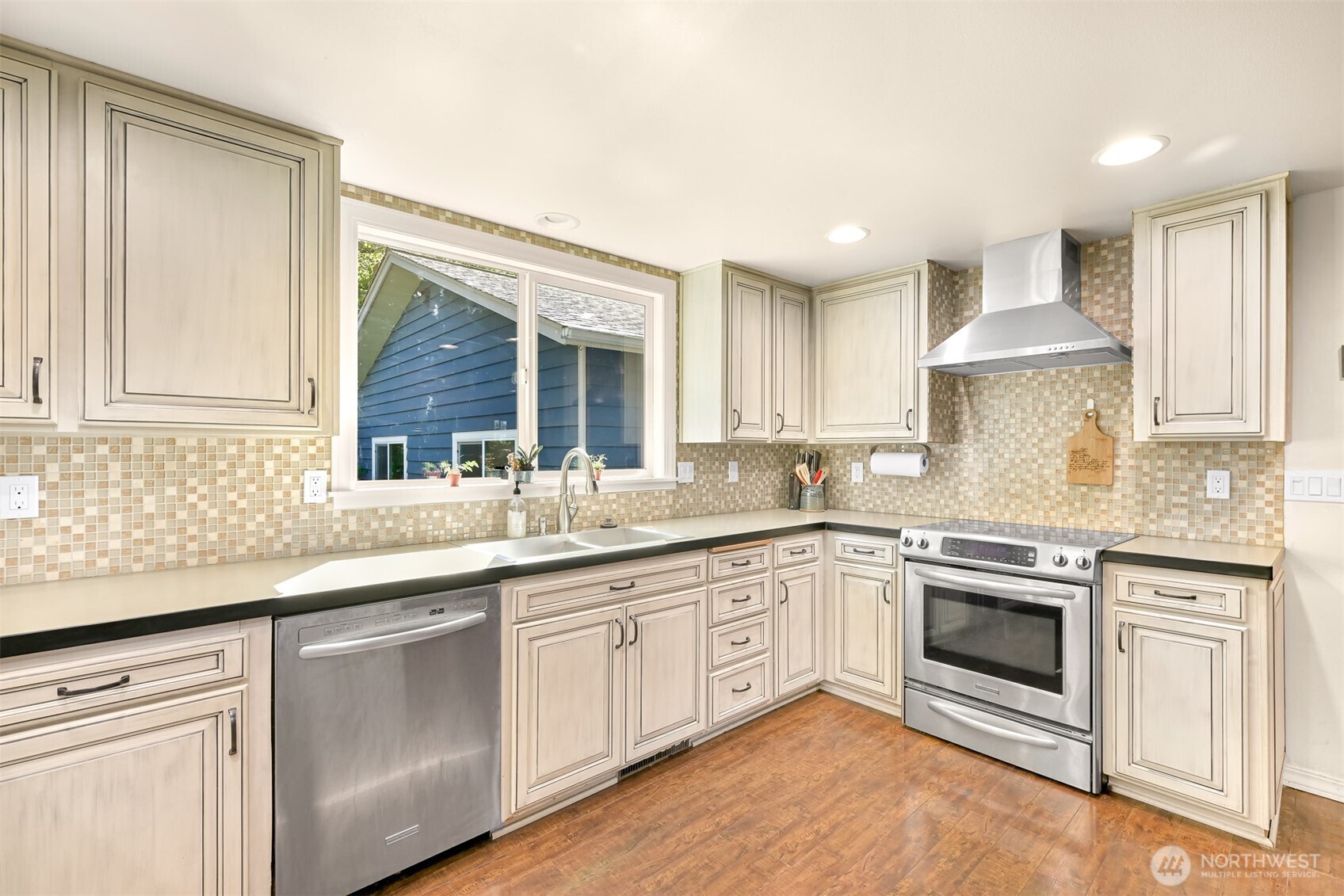 1300 West Axton Road Ferndale, WA 98248 - Photo 12 of 40 a kitchen with granite countertop white cabinets and white stainless steel appliances
