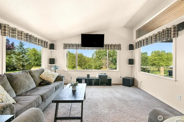 a view of a dining room with furniture a chandelier and wooden floor
