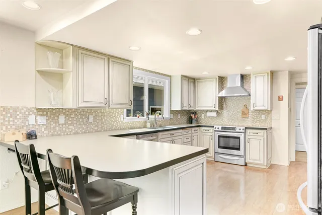 a kitchen with cabinets and stainless steel appliances