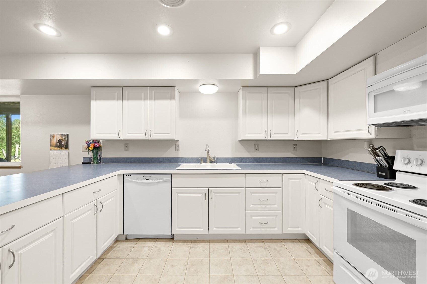 1300 West Axton Road Ferndale, WA 98248 - Photo 20 of 40 a kitchen with white cabinets appliances and a sink