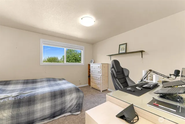 a view of a livingroom with furniture and a flat screen tv