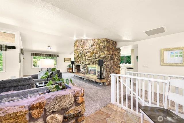 a kitchen with granite countertop kitchen island stainless steel appliances a stove a table and chairs