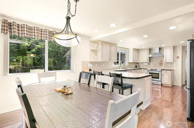 a kitchen with stainless steel appliances granite countertop a stove and a refrigerator