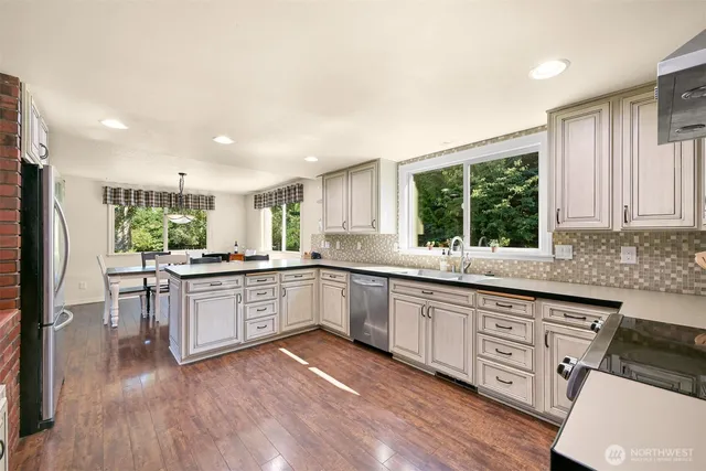 a kitchen with granite countertop white cabinets and a window