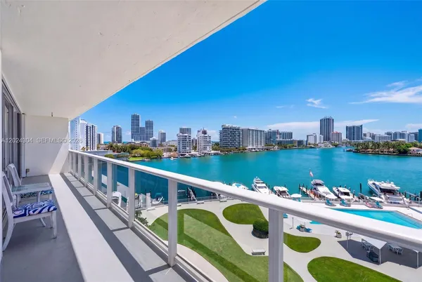 a view of balcony with city and outdoor seating