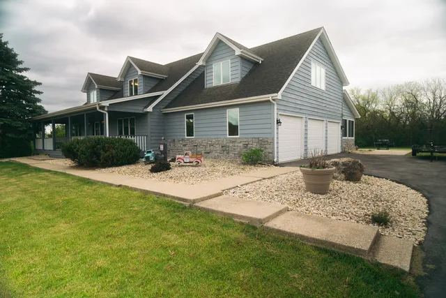 a front view of house with yard and trees around