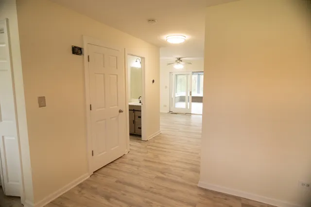a view of a hallway with wooden floor