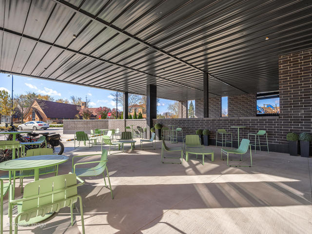 11 West Prospect Avenue, Unit 302 Mount Prospect, IL 60056 - Photo 33 of 34 a view of a patio with a table and chairs and a barbeque