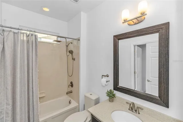 a bathroom with a shower a sink and a mirror