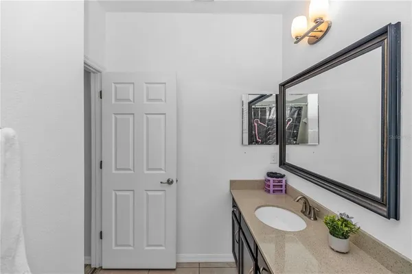 a bathroom with a sink vanity granite and a mirror