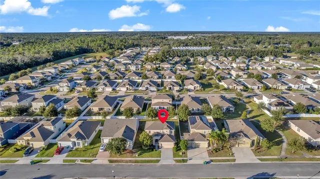 an aerial view of residential houses with outdoor space and street view