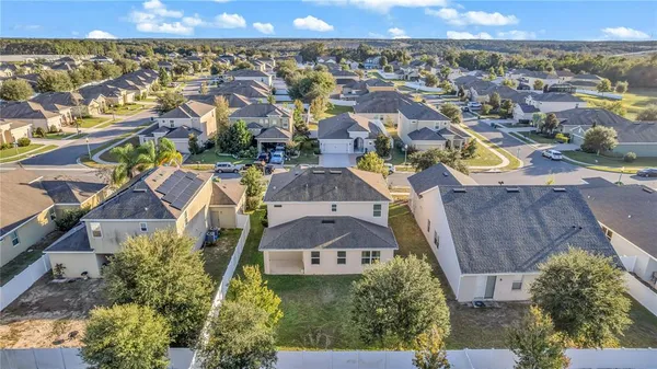 an aerial view of residential houses with outdoor space and swimming pool