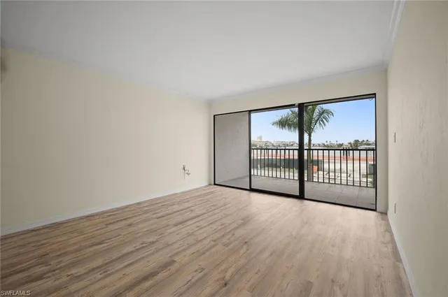 a view of a room with wooden floor and windows