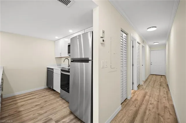 a view of a refrigerator in kitchen and wooden floor