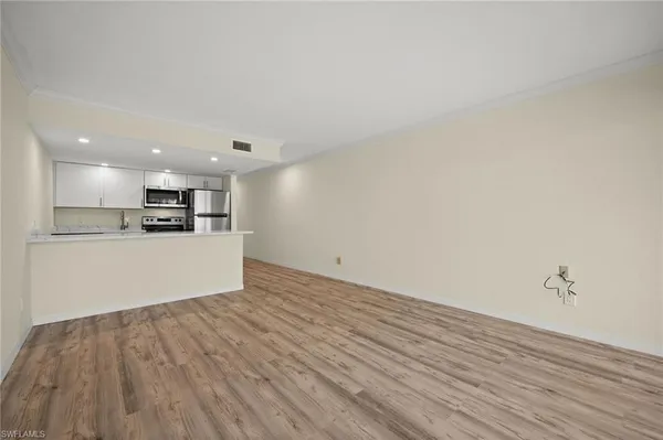 a view of kitchen with wooden floor and window