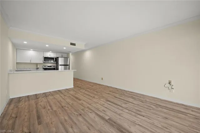 a view of kitchen with wooden floor and window