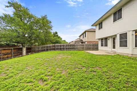 a view of a house with backyard and sitting area