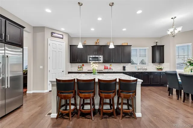 a large kitchen with a table and chairs