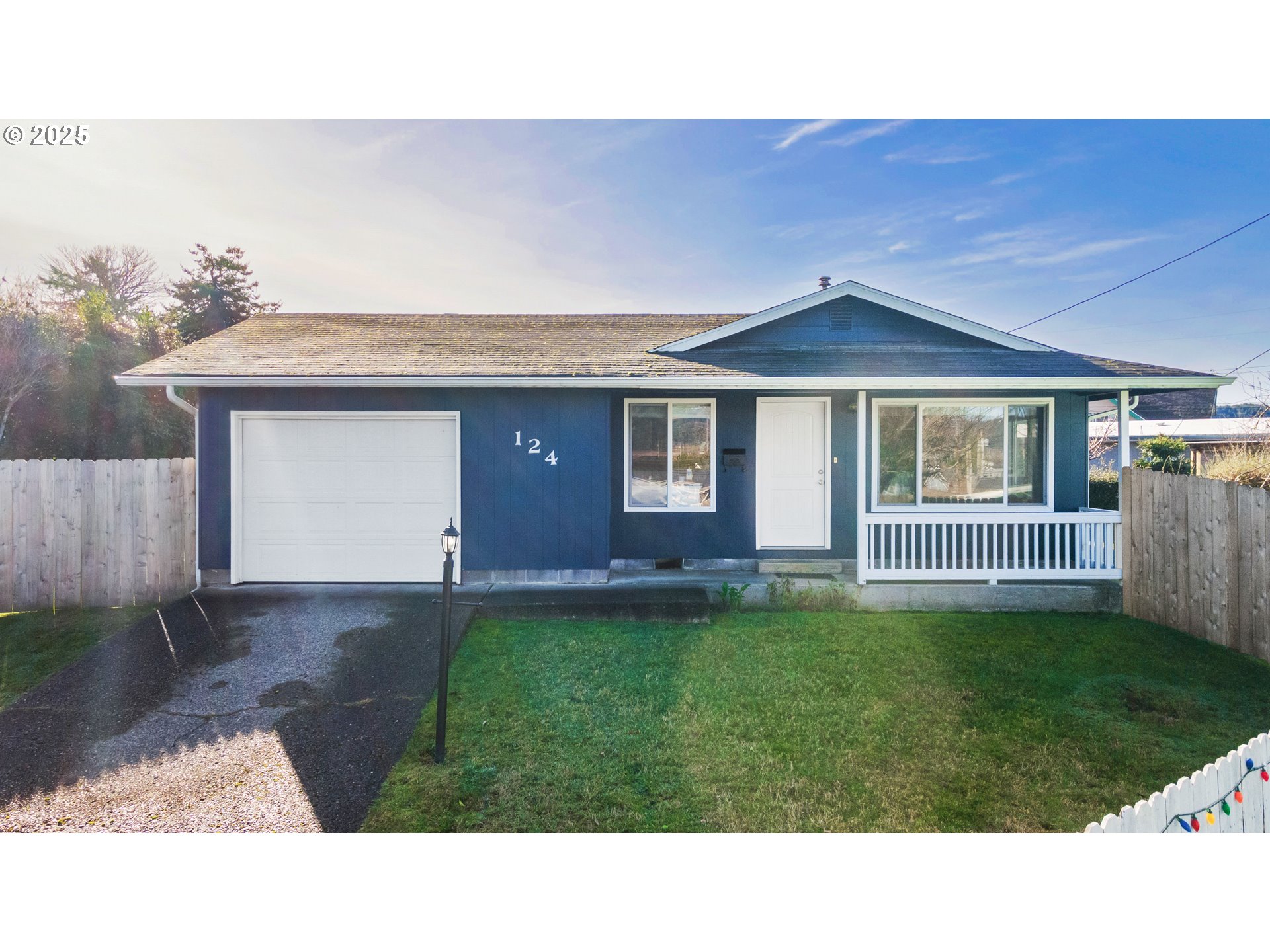 124 Holly Court Reedsport, OR 97467 - Photo 1 of 30 a front view of a house with a yard and garage