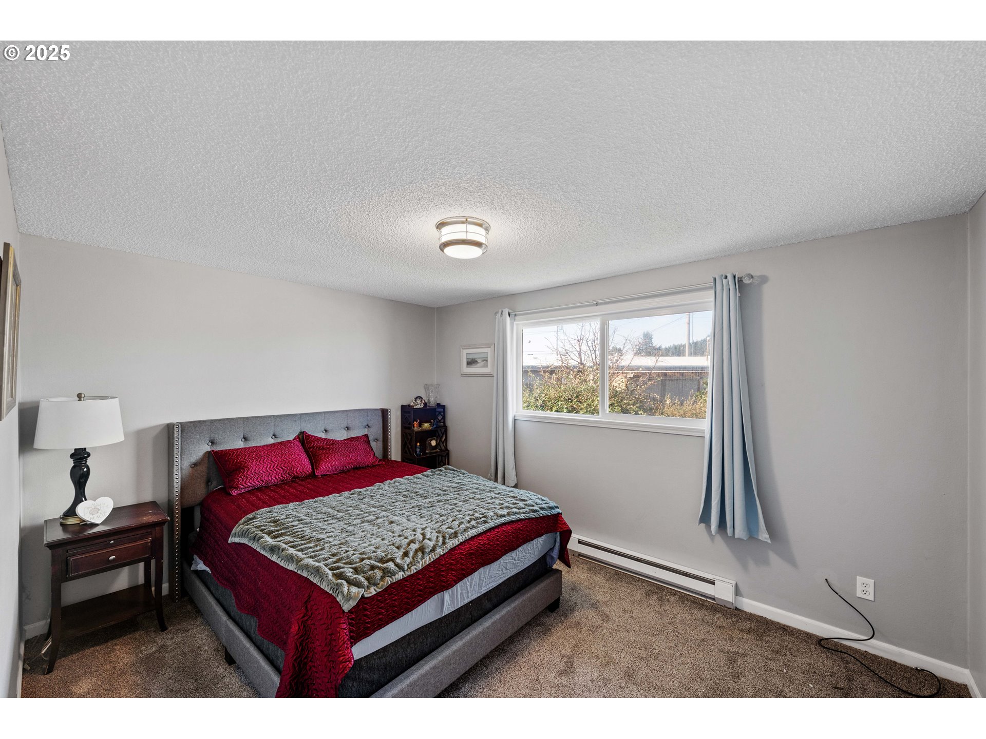 124 Holly Court Reedsport, OR 97467 - Photo 14 of 30 a bedroom with a bed and a window