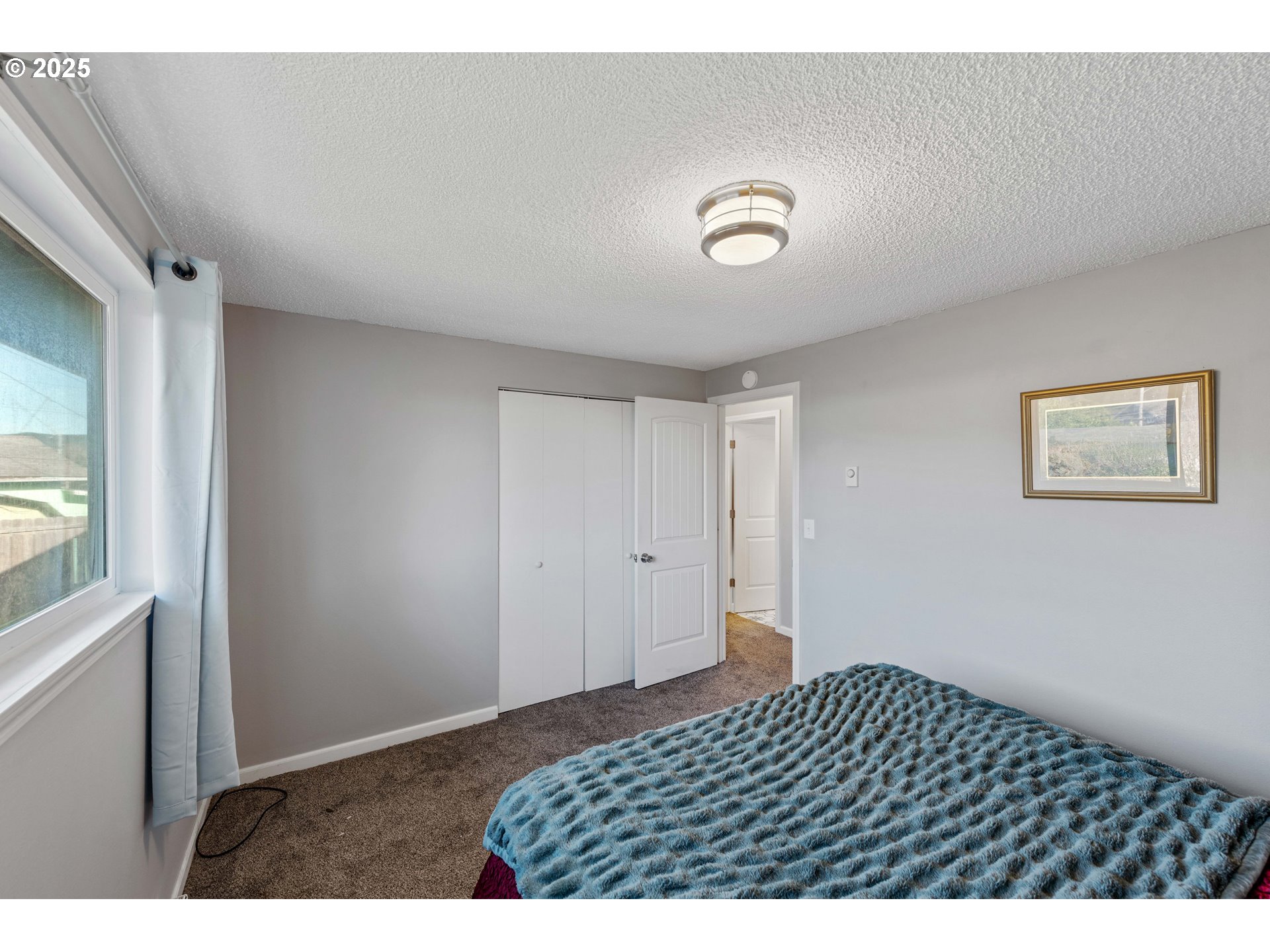 124 Holly Court Reedsport, OR 97467 - Photo 15 of 30 a bedroom with a bed and a window