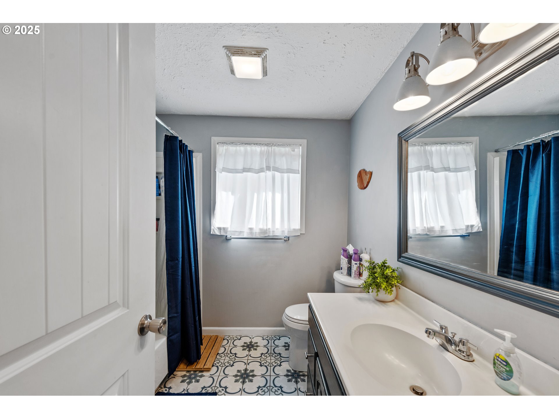 124 Holly Court Reedsport, OR 97467 - Photo 16 of 30 a bathroom with a sink a vanity and a mirror