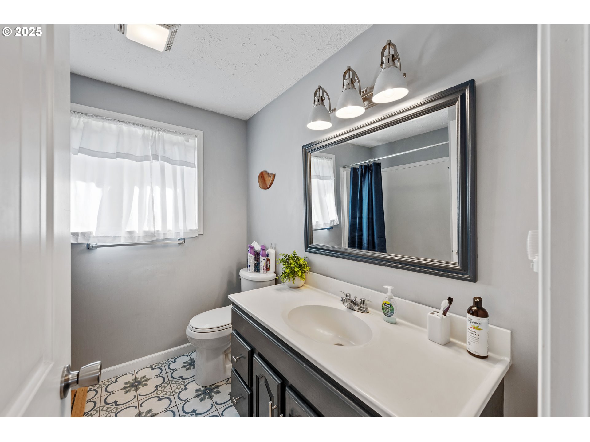 124 Holly Court Reedsport, OR 97467 - Photo 17 of 30 a bathroom with a sink and a mirror