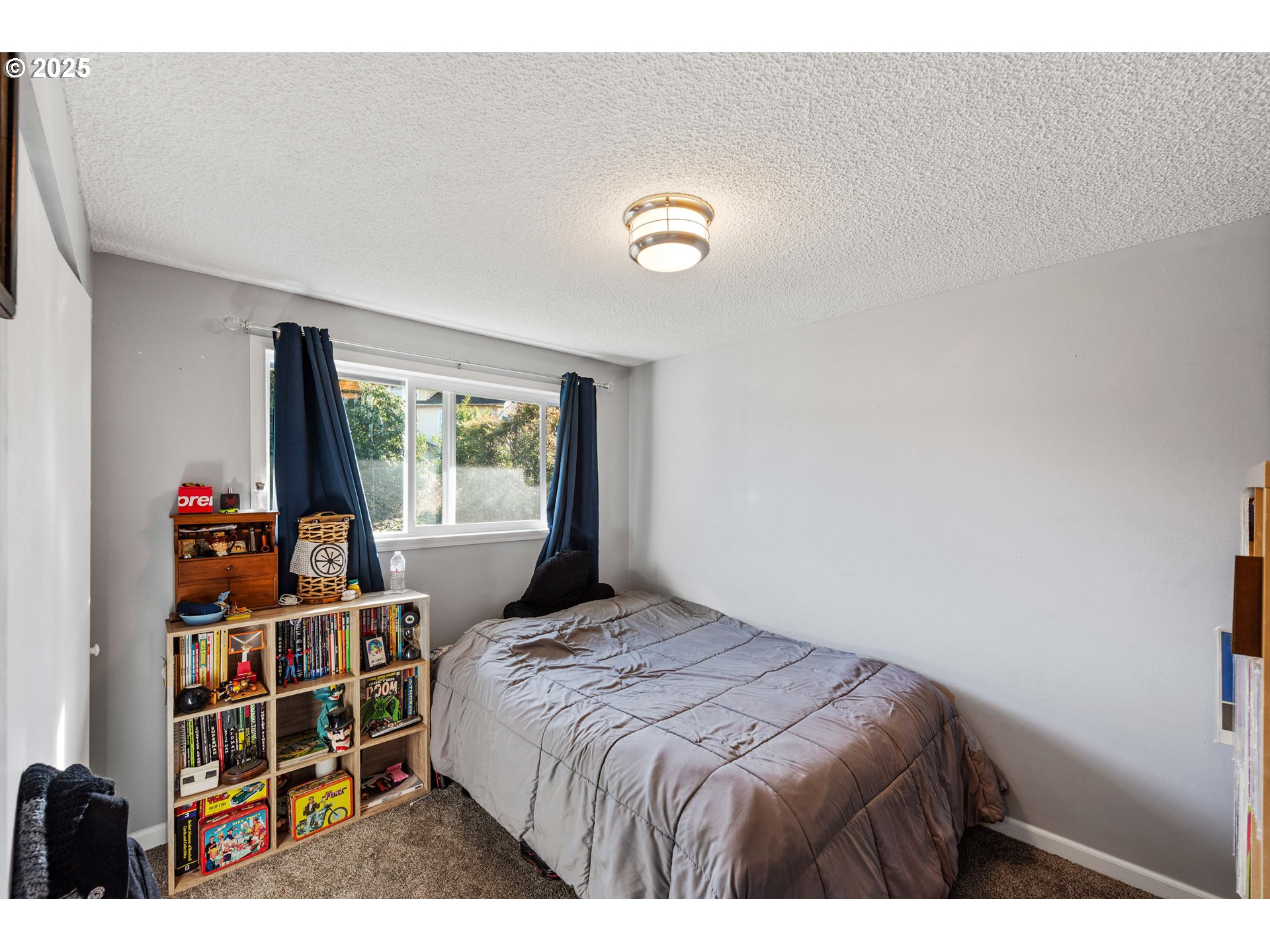 124 Holly Court Reedsport, OR 97467 - Photo 20 of 30 a bedroom with a bed and a bookshelf