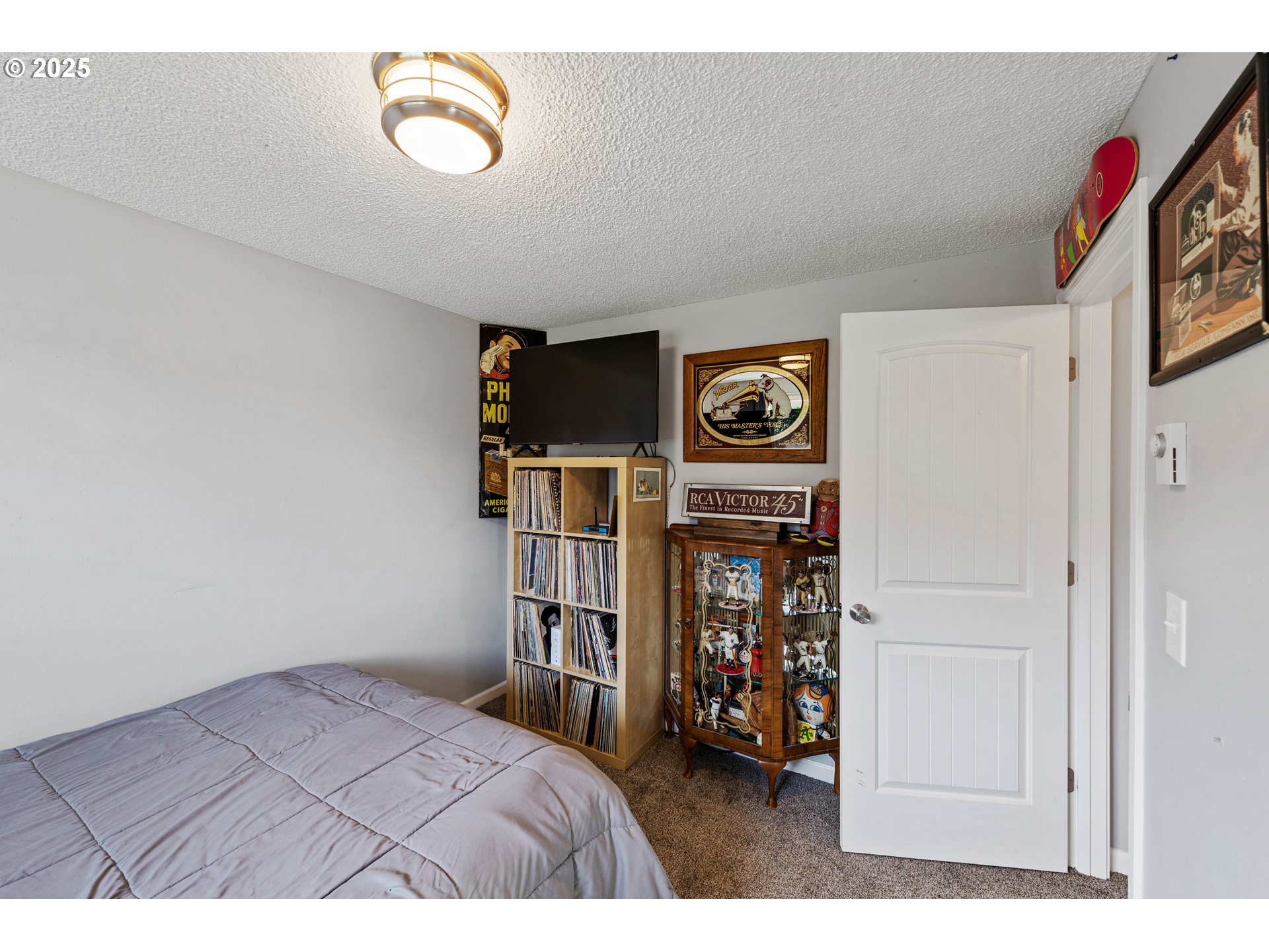 124 Holly Court Reedsport, OR 97467 - Photo 22 of 30 a bed room with a bed and a book shelf