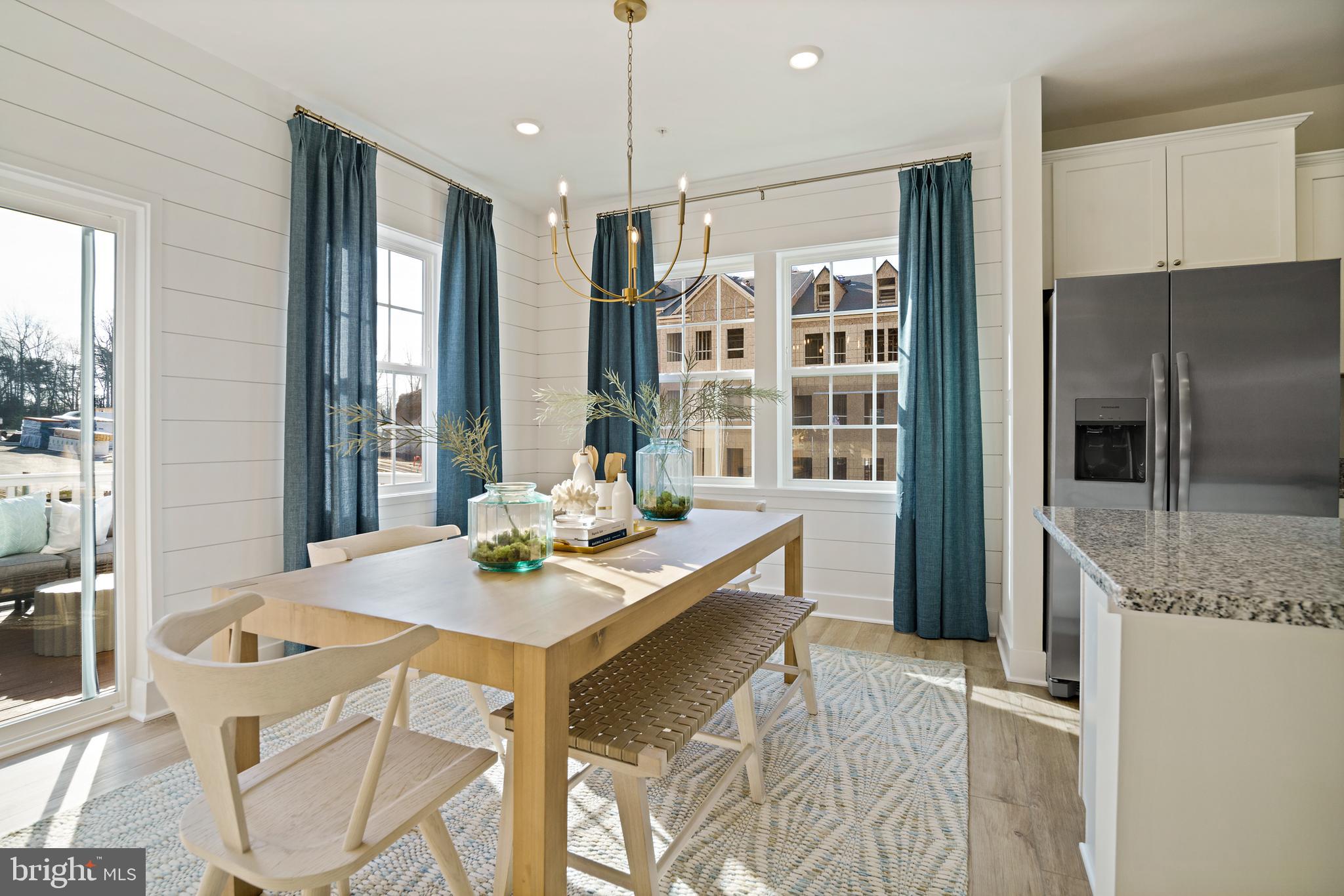 23600 Crosswinds Way California, MD 20619 - Photo 14 of 55 a kitchen with a table chairs refrigerator and microwave
