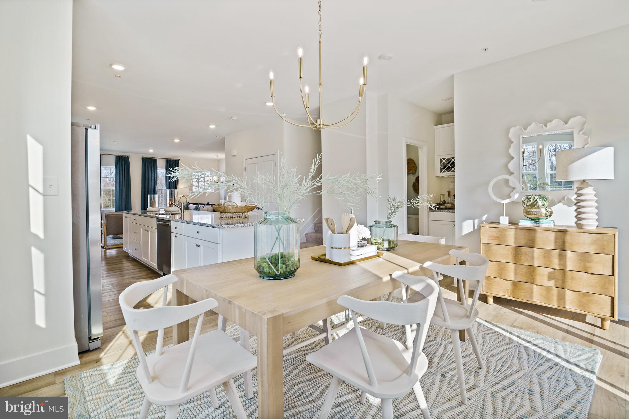 23600 Crosswinds Way California, MD 20619 - Photo 16 of 55 a kitchen with stainless steel appliances kitchen island granite countertop a refrigerator a stove a sink dishwasher with a dining table and chairs