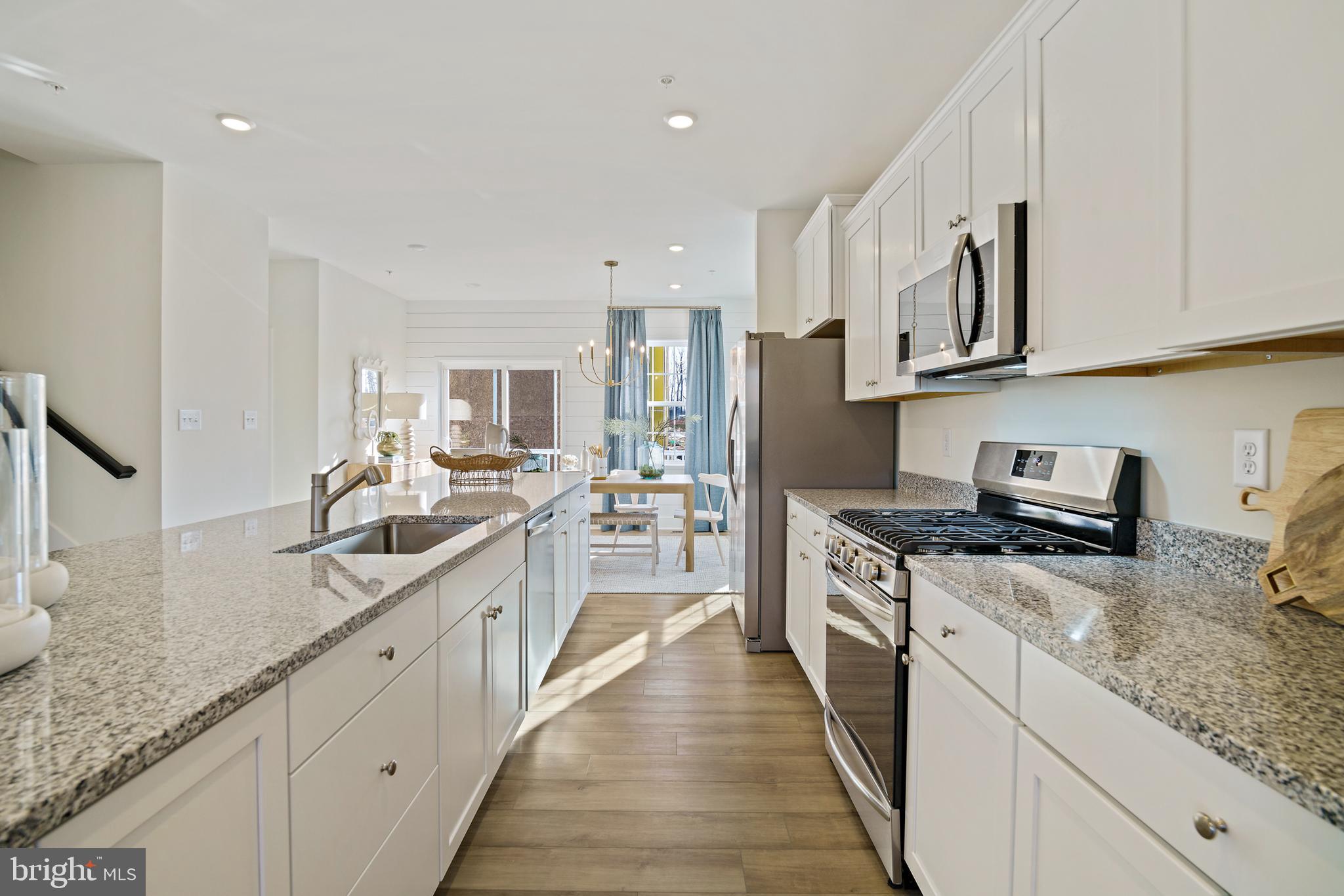 23600 Crosswinds Way California, MD 20619 - Photo 17 of 55 a large kitchen with stainless steel appliances granite countertop a lot of counter space and wooden floor