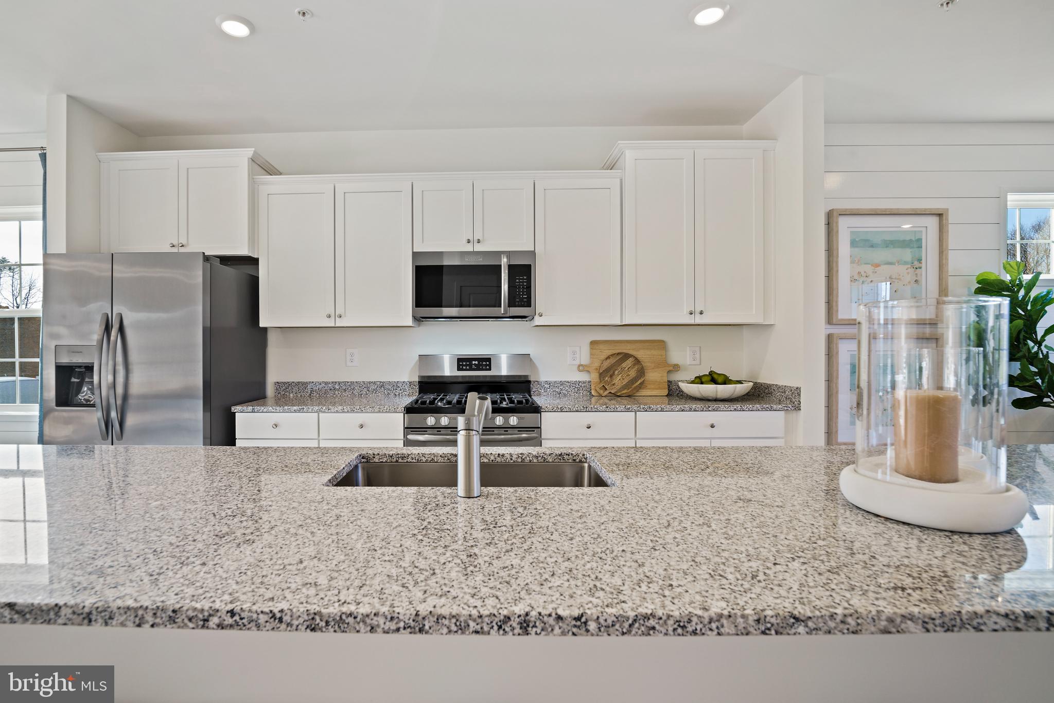 23600 Crosswinds Way California, MD 20619 - Photo 22 of 55 a kitchen with granite countertop a refrigerator sink stove microwave and cabinets