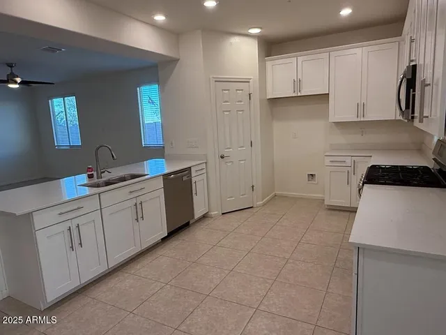 a kitchen with a sink and cabinets