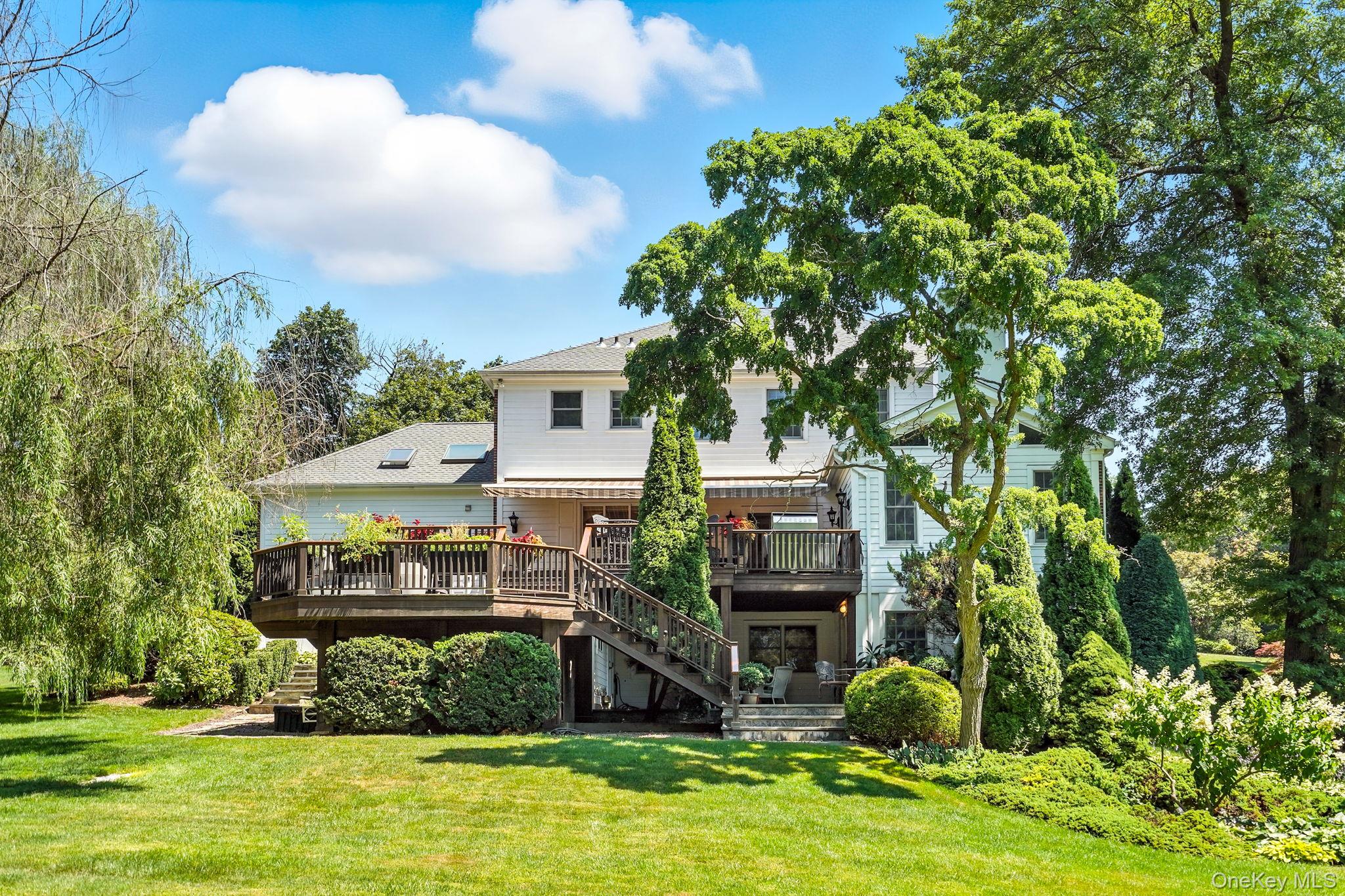 33 Hevelyne Road Elmsford, NY 10523 - Photo 43 of 43 Rear view of house featuring a deck, stairway, and a yard