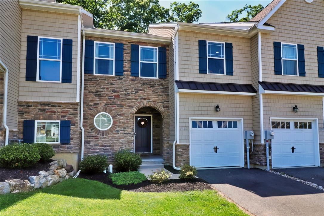4502 Benjamin Court Emmaus, PA 18049 - Photo 1 of 53 Stone and siding create an inviting exterior for these charming townhomes, featuring ample windows and attached garages.