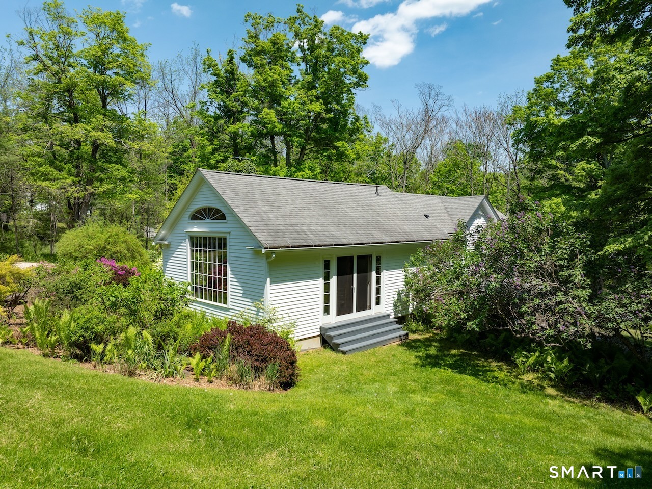 329 Housatonic River Road Salisbury, CT 06031 - Photo 21 of 32 a front view of a house with a garden