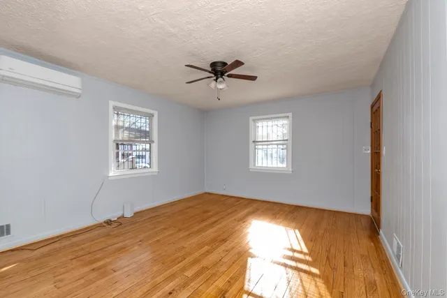 a view of a room with a window and a ceiling fan