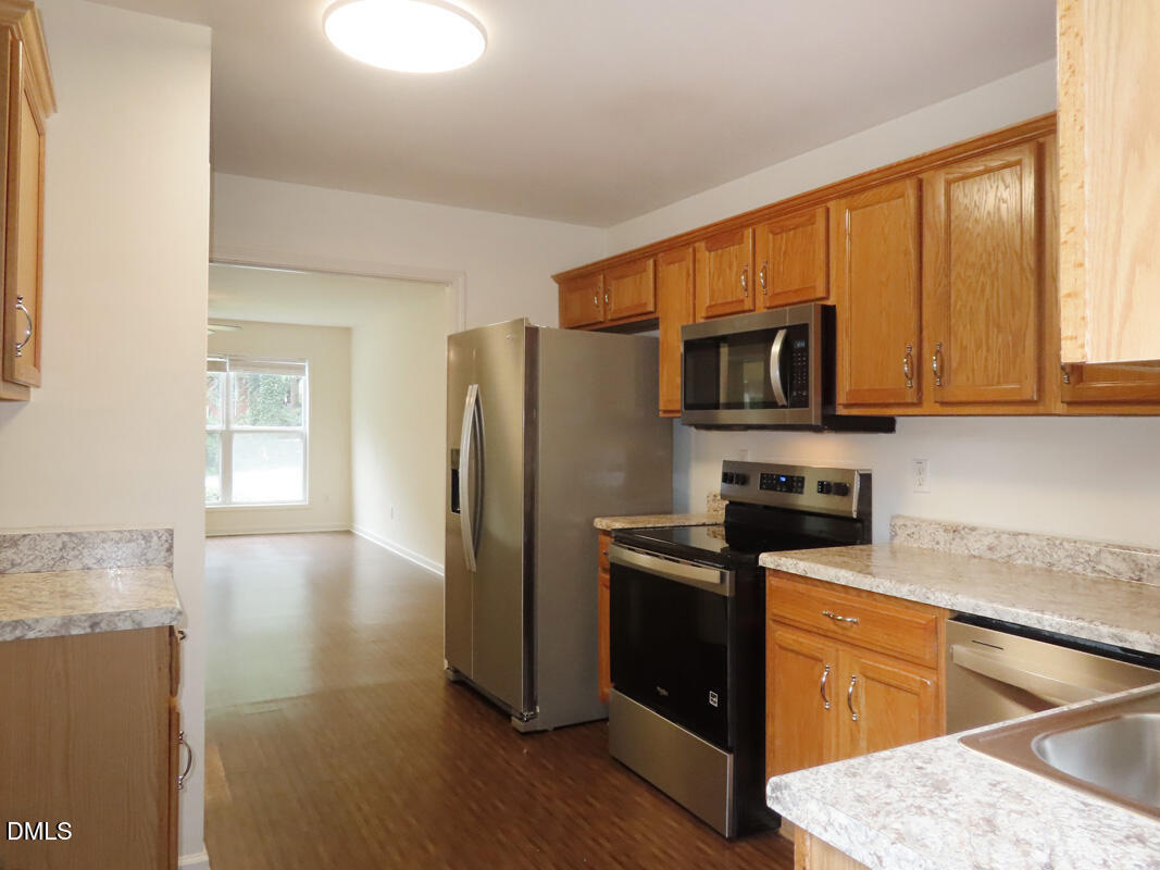 314 Davie Road, Unit B Carrboro, NC 27510 - Photo 5 of 15 a kitchen with stainless steel appliances granite countertop a refrigerator stove microwave and sink