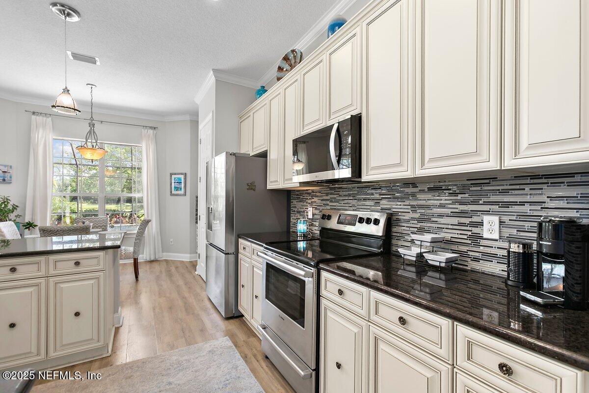 417 Blagdon Court Jacksonville, FL 32225 - Photo 12 of 43 a kitchen with white cabinets and appliances