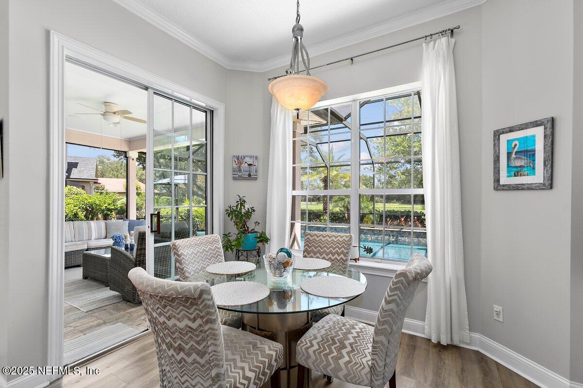 417 Blagdon Court Jacksonville, FL 32225 - Photo 14 of 43 a dining room with furniture a chandelier and wooden floor